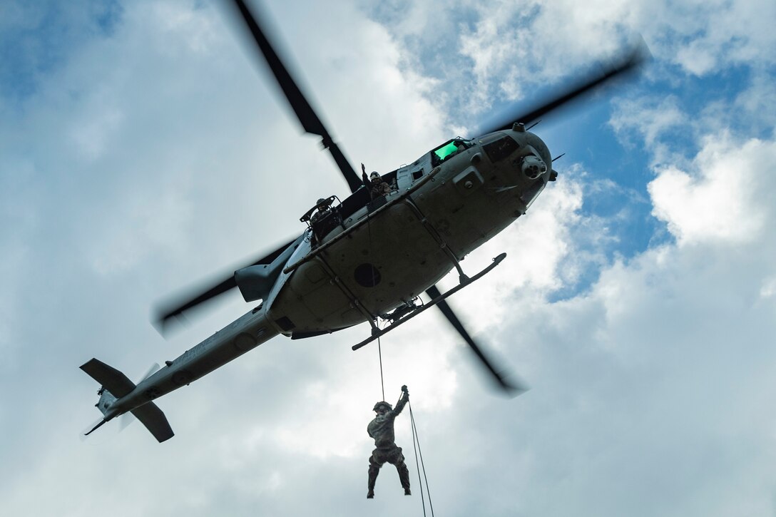 U.S. Marines with III Marine Expeditionary Force rappel from a UH-1Y Venom assigned to Marine Light Attack Helicopter Squadron 169 during special patrol insertion and extraction training at Landing Zone Starling, Camp Schwab, Okinawa, Japan, Sept. 21, 2023. Helicopter rope suspension techniques teach Marines proper knots, rappelling techniques and build confidence for maneuvering from air to ground. (U.S. Marine Corps photo by Cpl. Tyler Andrews)