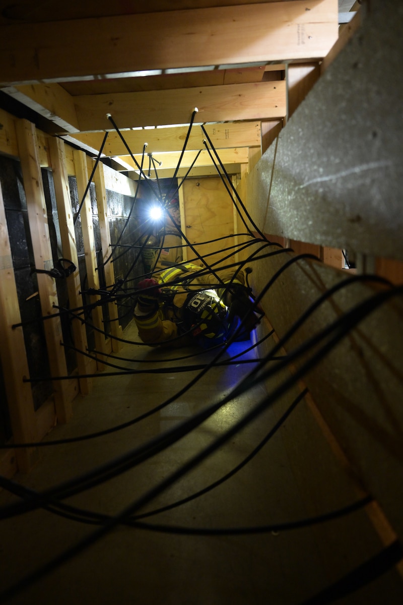 Anthony Mason, a Youngstown Air Reserve Station firefighter, navigates a portion of a confined spaces obstacle course at YARS, Sept. 21, 2023.