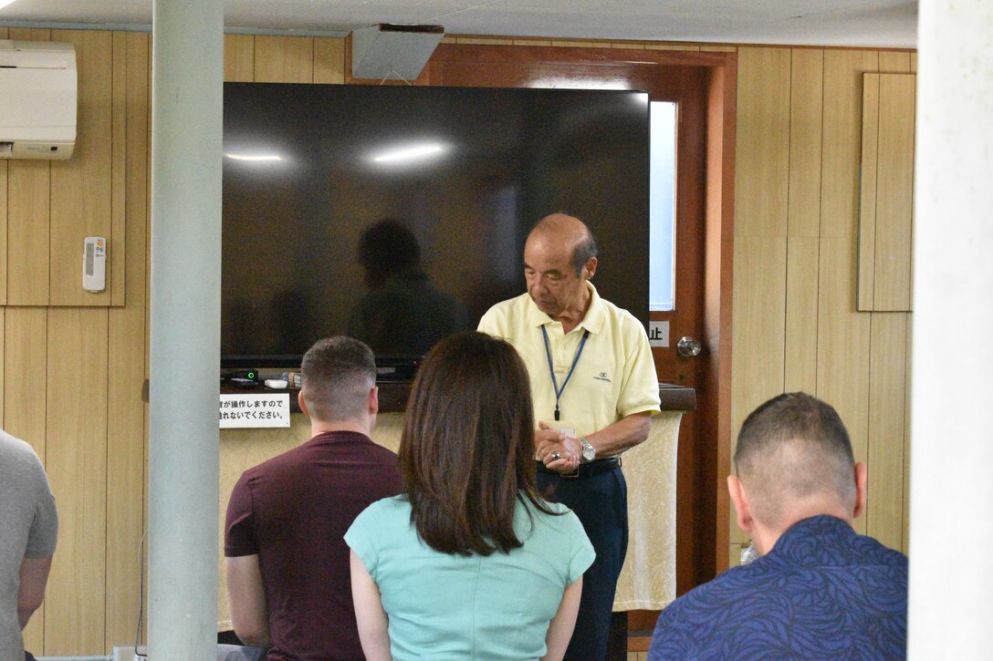“Greg” Kouta, a Mikasa Preservation Society advisor and retired Japanese Maritime Self-Defense Force captain, pauses during his talks with members from the Combined Arms Training Center during their visit of the historical Japanese memorial Mikasa warship, September 13, 2023. (U.S. Marine Corps photo by Song Jordan)