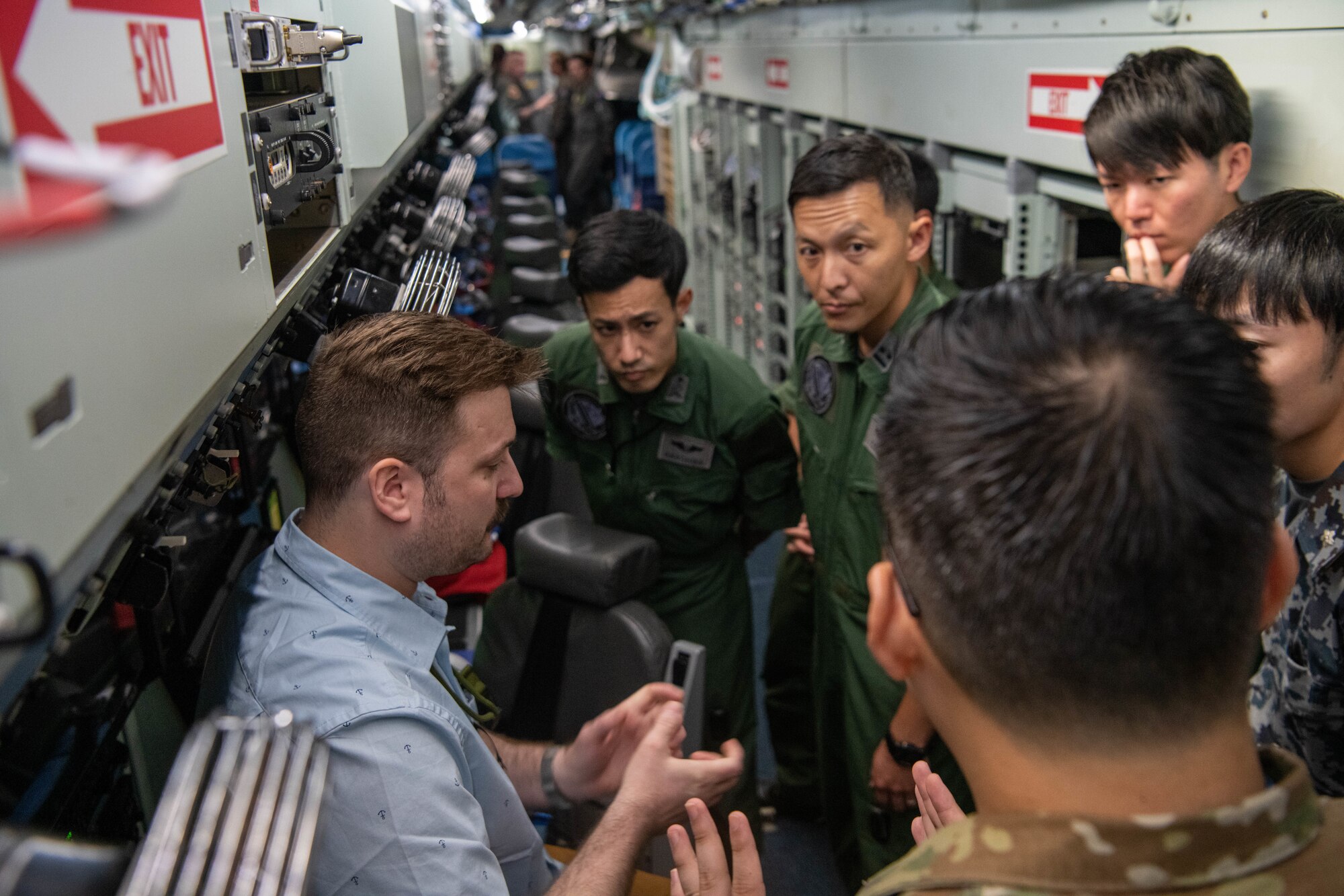 An Airman translates RC-135 Rivet Joint capabilities to JASDF service members.
