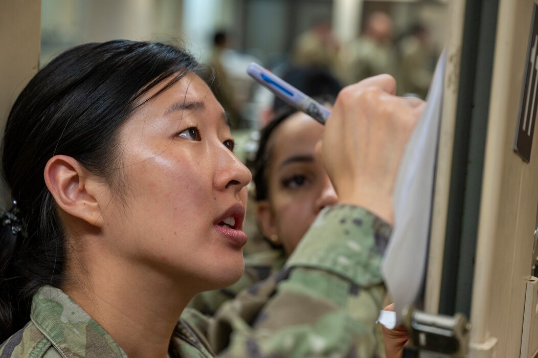 Image of an Airman writing during training.