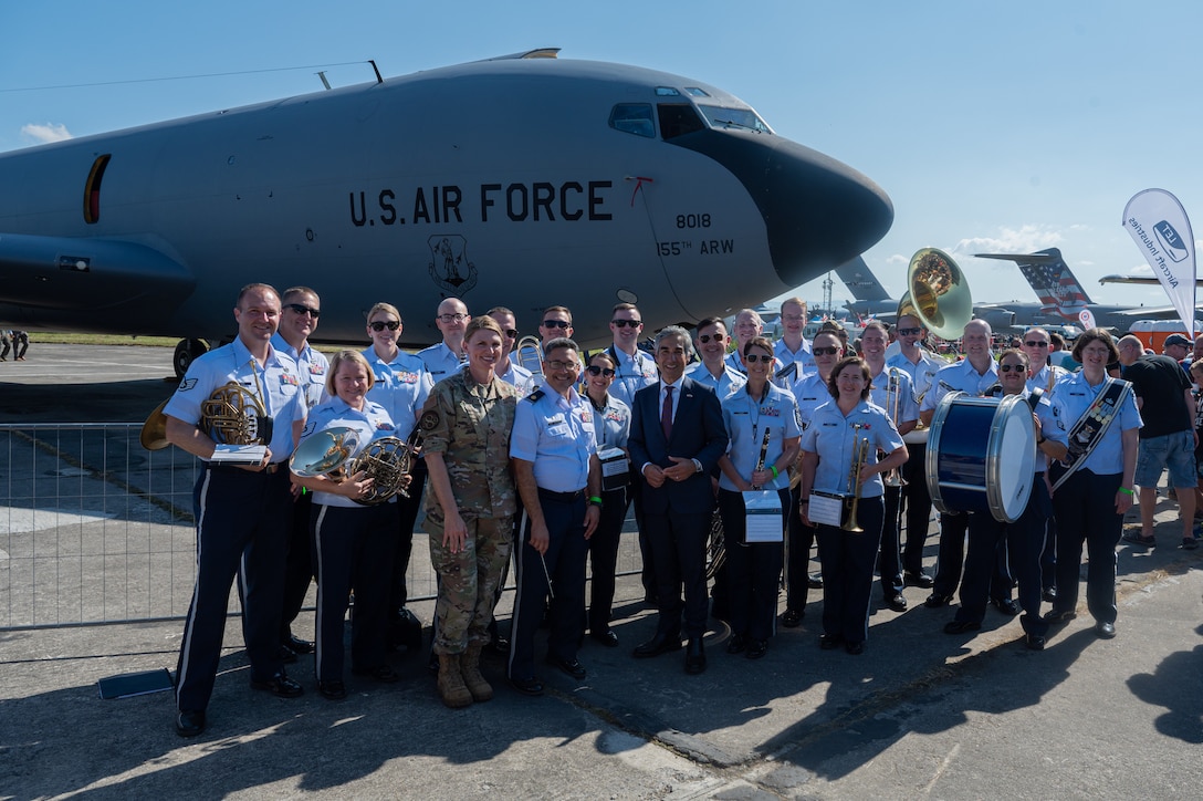 Bijan Sabet, center, U.S. Ambassador to the Czech Republic, and members of the U.S. Air Forces in Europe Ceremonial Band, stand together in front of a KC-135 Stratotanker aircraft from the 155th Air Refueling Wing, Lincoln, Nebraska, during the NATO Days event at Leoš Janáček Airport in Ostrava, Czech Republic, Sept. 16, 2023. The USAFE Band serves as a bridge to increase cultural ties and enrich the partnerships between the U.S. and Czech Republic through music.