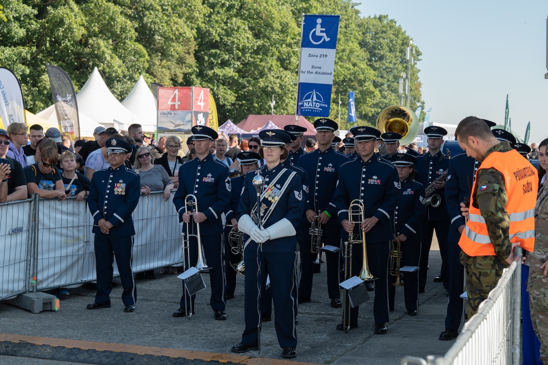 U.S. Air Force Airmen assigned to the U.S. Air Forces in Europe Ceremonial Band, prepare to march during the opening ceremony of the NATO Days event at Leoš Janáček Airport in Ostrava, Czech Republic, Sept. 16, 2023. The event was originally a regional public presentation of armed forces, police, and rescuers, but has since evolved into the largest air, military and security show in Central Europe. (U.S. Air Force photo by Airman 1st Class Christopher Campbell)