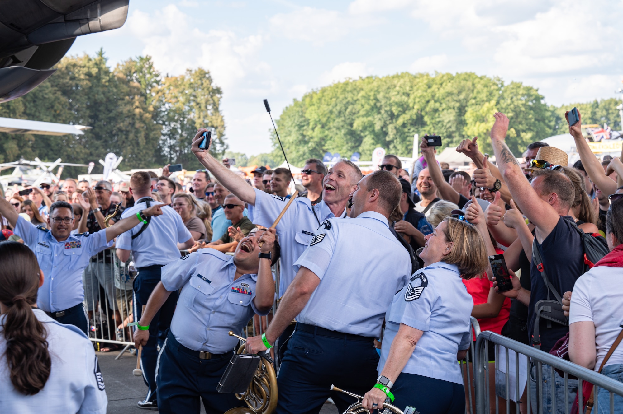 U.S. Air Force Airmen assigned to the U.S. Air Forces in Europe Ceremonial Band, pose for a photo with a spectator’s phone during NATO Days event at Leoš Janáček Airport in Ostrava, Czech Republic, Sept. 17, 2023.