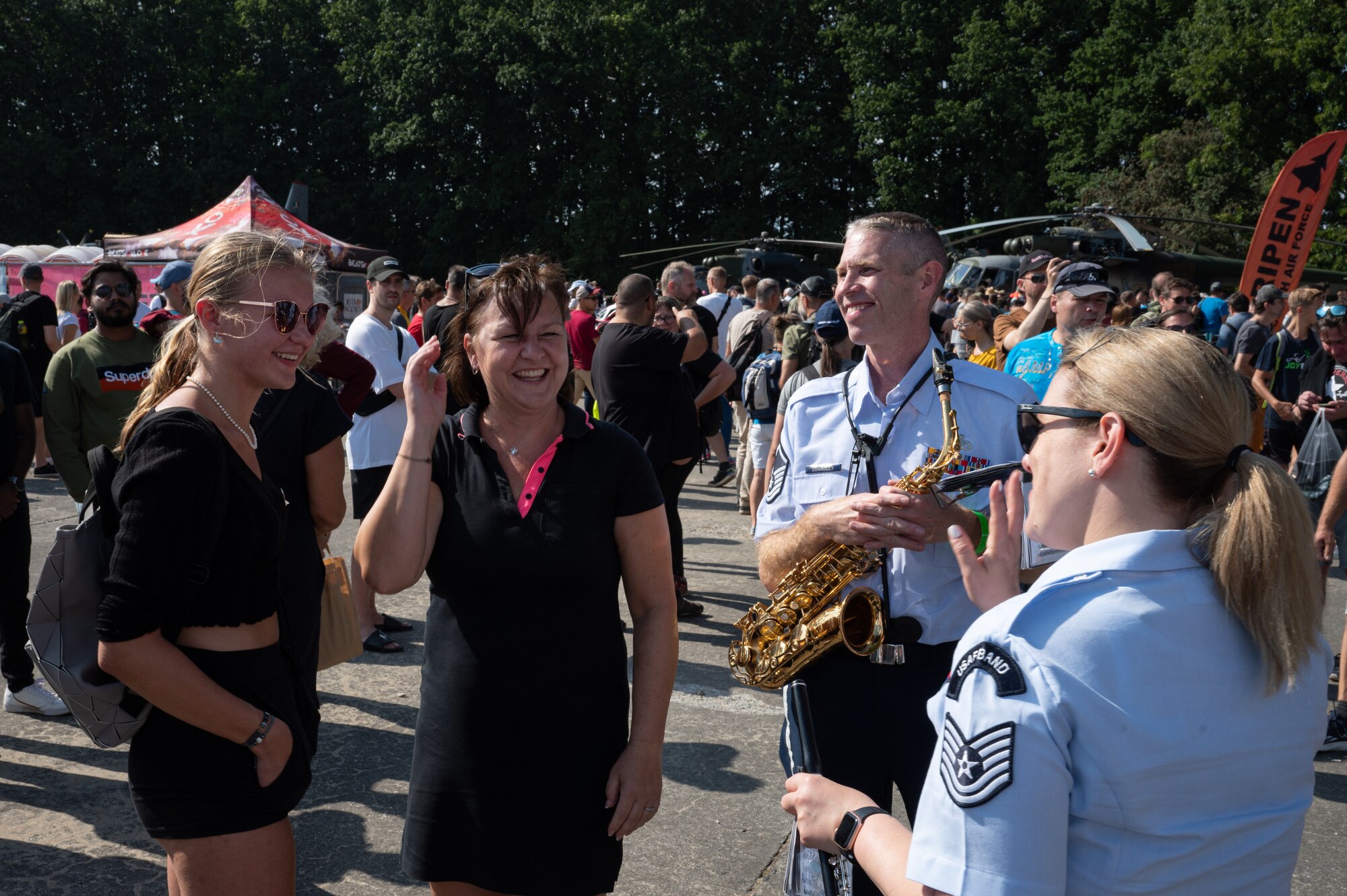 U.S. Air Force Airmen assigned to the U.S. Air Forces in Europe Ceremonial Band, speak with spectators during the NATO Days event at Leoš Janáček Airport in Ostrava, Czech Republic, Sept. 17, 2023.