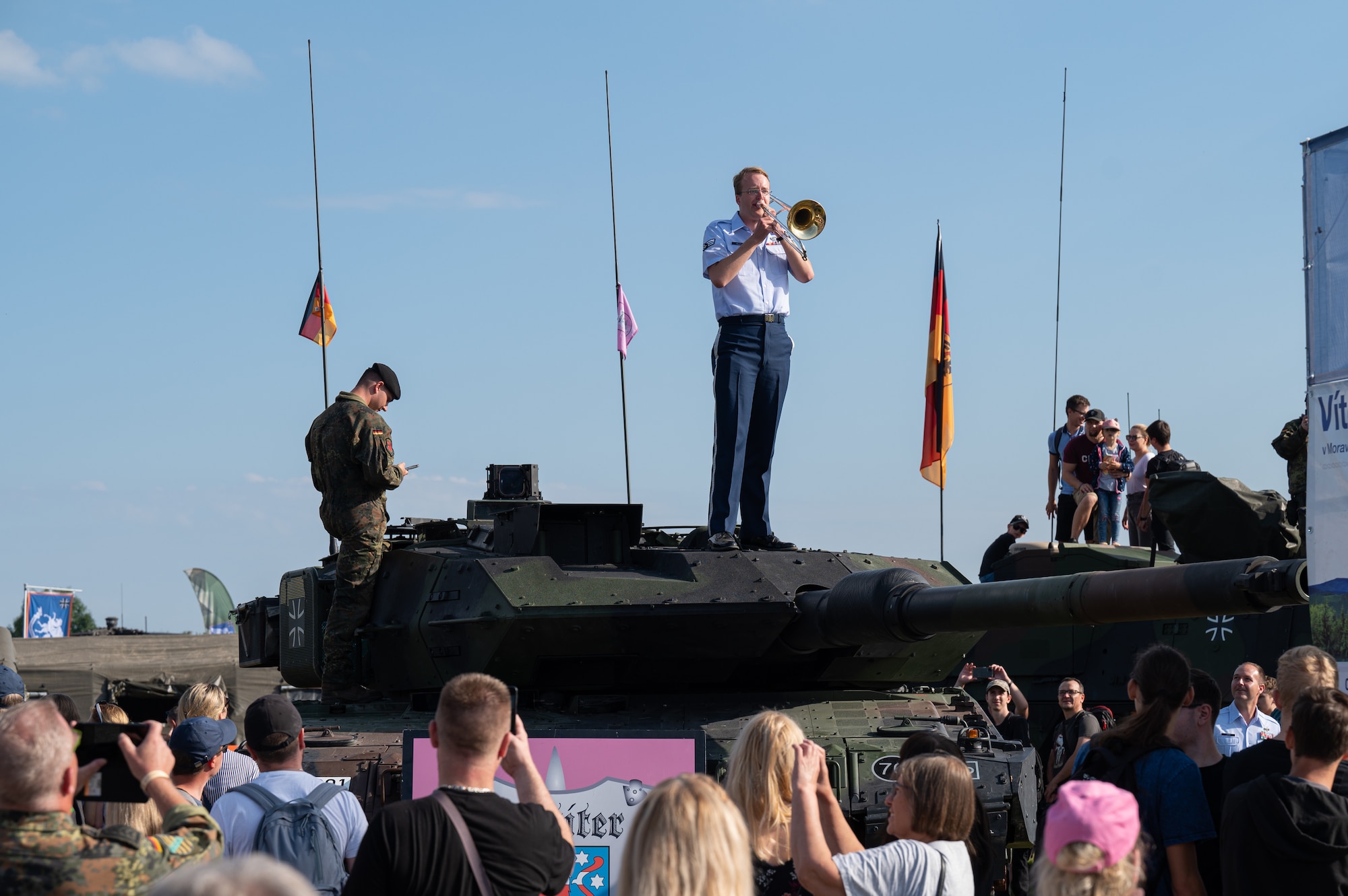 U.S. Air Force Senior Airman Tom Kelley, U.S. Air Forces in Europe Ceremonial Band trombonist, performs a tune while standing on a German military tank during the NATO Days event at Leoš Janáček Airport in Ostrava, Czech Republic, Sept. 17, 2023.