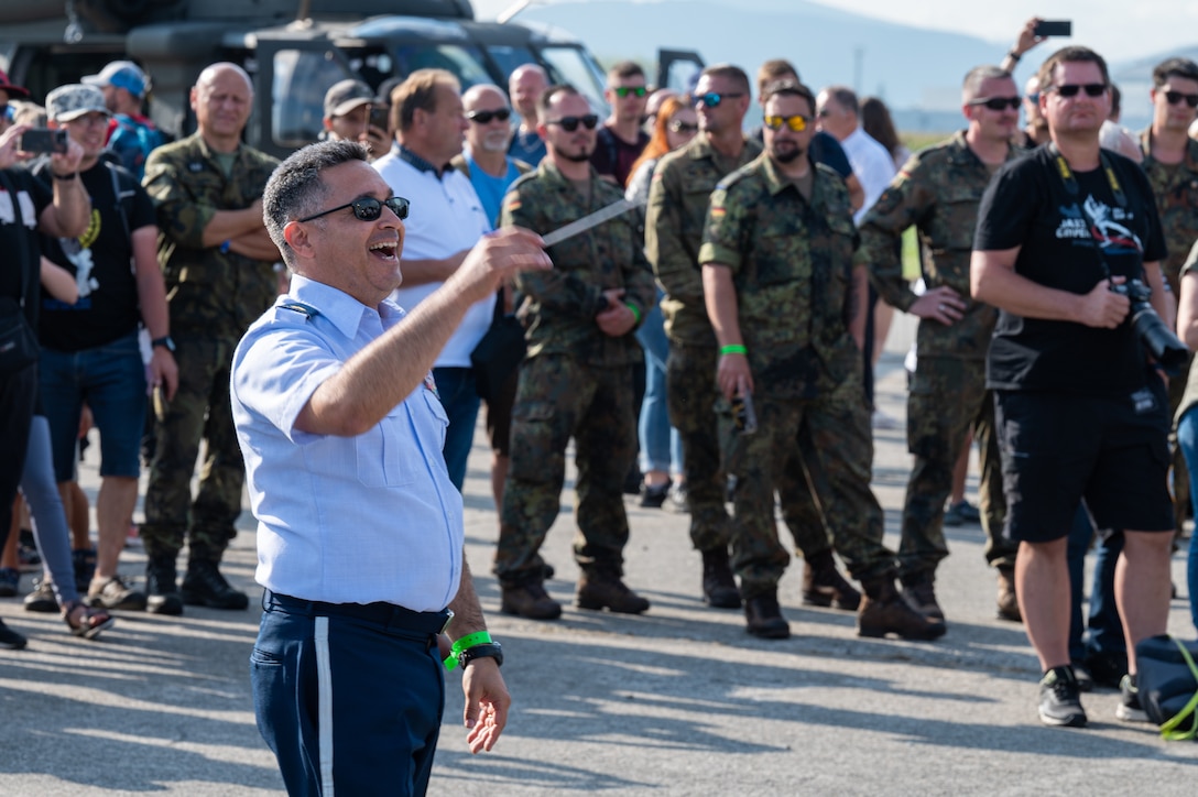 U.S. Air Force Maj. Rafael F. Toro-Quiñones, U.S. Air Forces in Europe Band commander and conductor, conducts during the NATO Days event at Leoš Janáček Airport in Ostrava, Czech Republic, Sept. 17, 2023. The USAFE Band serves as a bridge to increase cultural ties and enrich the partnerships between the U.S. and Czech Republic through music. (U.S. Air Force photo by Airman 1st Class Christopher Campbell)