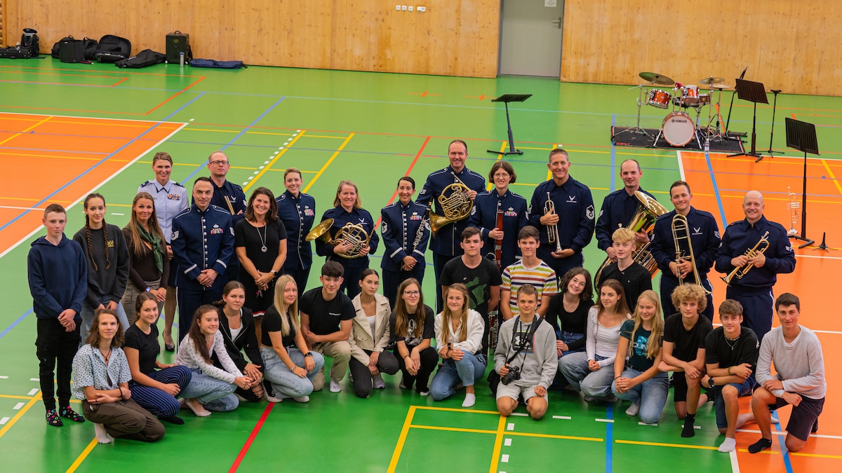 U.S. Air Force Airmen assigned to the U.S. Air Forces in Europe Band and Czech students stand together at Silesian Grammar School Opava in Opava, Czech Republic, Sept. 14, 2023.