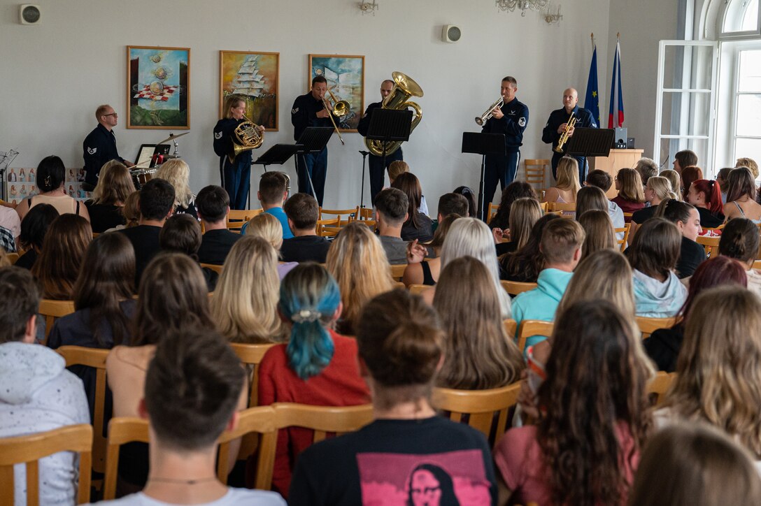 Czech students watch Airmen assigned to the U.S. Air Forces in Europe Band’s Five Star Brass Quintet with drums, perform at the Secondary School of Nursing in Opava, Czech Republic, Sept. 14, 2023. U.S. Air Force bands provide an essential element in inspiring servicemembers, fostering the support of citizens, and the promotion of national interests at home and abroad. (U.S. Air Force photo by Airman 1st Class Christopher Campbell)