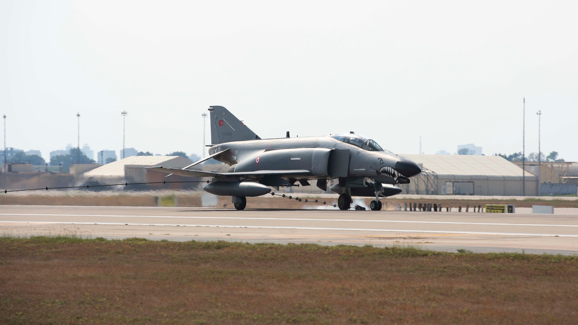 An F-4 Fighter jets rolls down a runway