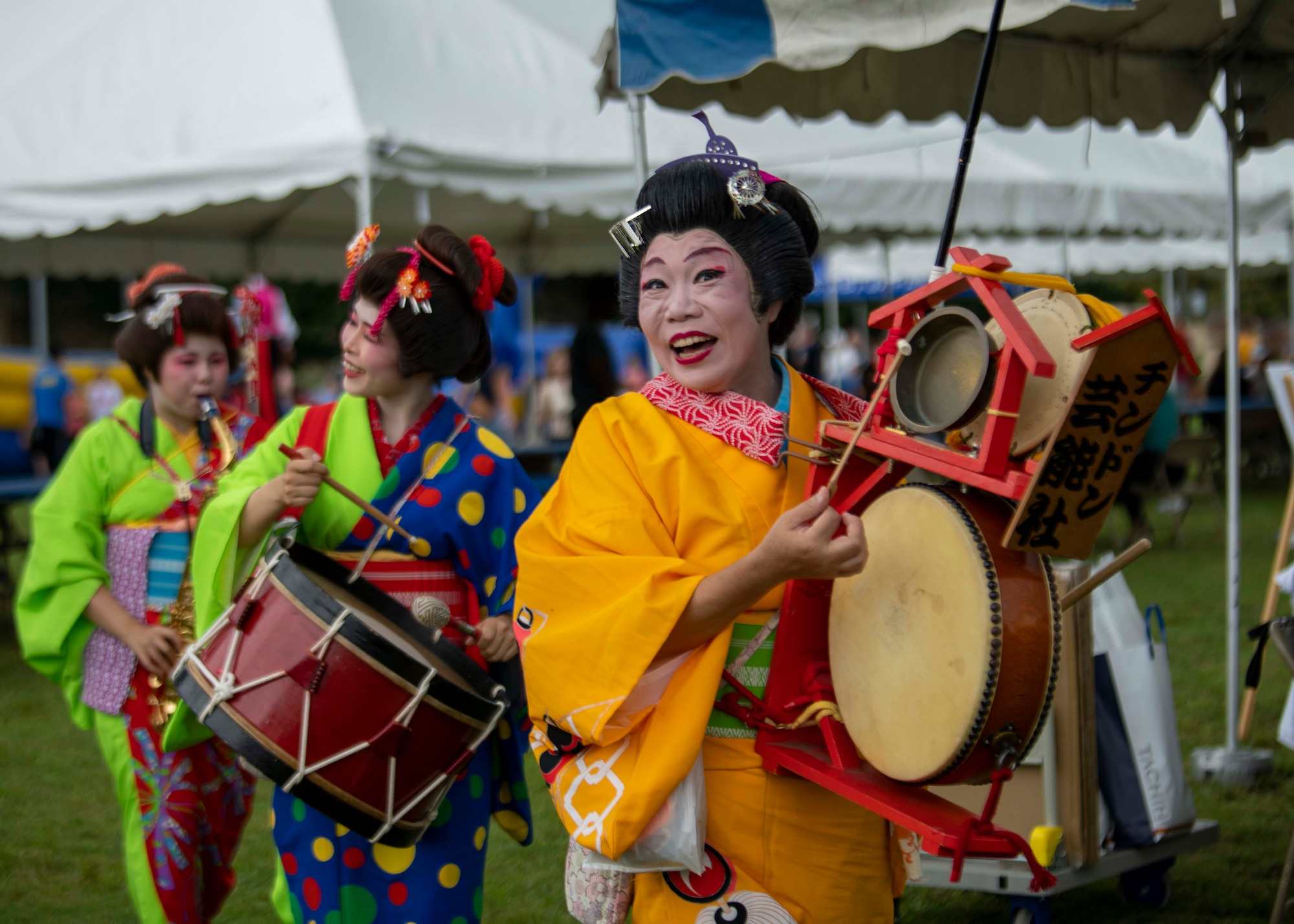 A group of dancers perform with drums.