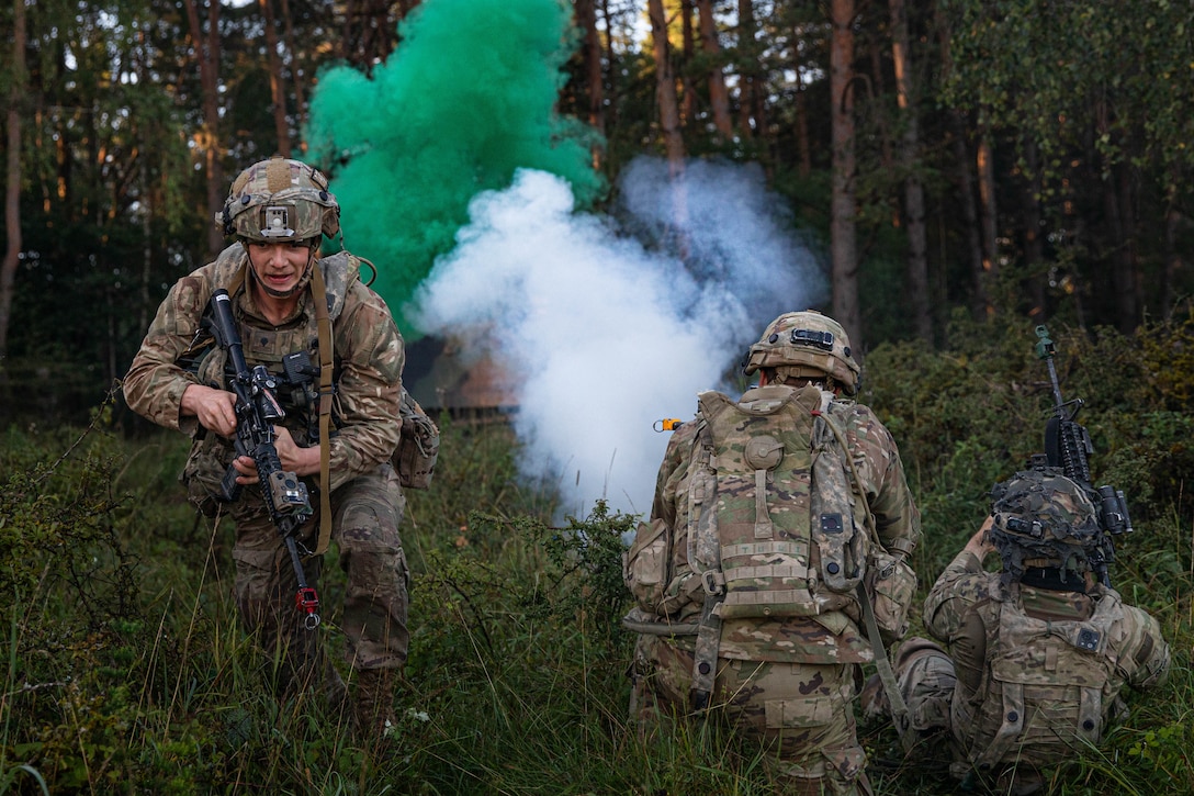 Green smoke appears while soldiers participate in a training exercise.