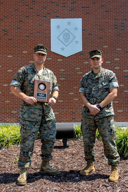 U.S. Marine Corps Gunnery Sgt. Gary Hohn, spectrum manager, Marine Forces Special Operations Command, and Chief Warrant Officer 2 Matthew Evans, electromagnetic spectrum officer, pose for a photo after receiving the annual Navy-Marine Corps Spectrum Excellence Team Award