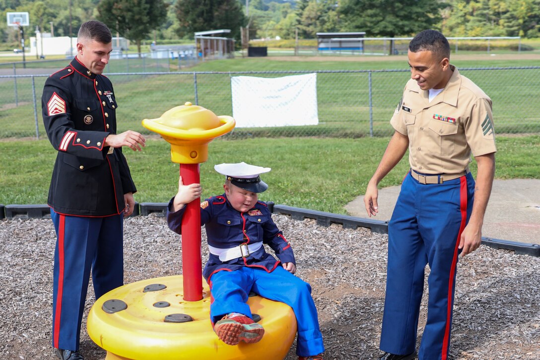 U.S. Marine Corps Staff Sgt. Corbin Messner, left, a recruiter with Recruiting Station Columbus, 4th Marine Cops District and Sgt. Daron Reed, right, with Recruiting Station Cleveland, 4th Marine Corps District, spends time with Andrew Miller in Conesville, Ohio, September 18, 2023.  Andrew, 8, was diagnosed with terminal cancer and has wanted to be a Marine since he was four years old. The Marines visited him to brighten his day and talk about their experiences being Marines. (U.S. Marine Corps photo by Cpl. Austin Molla)