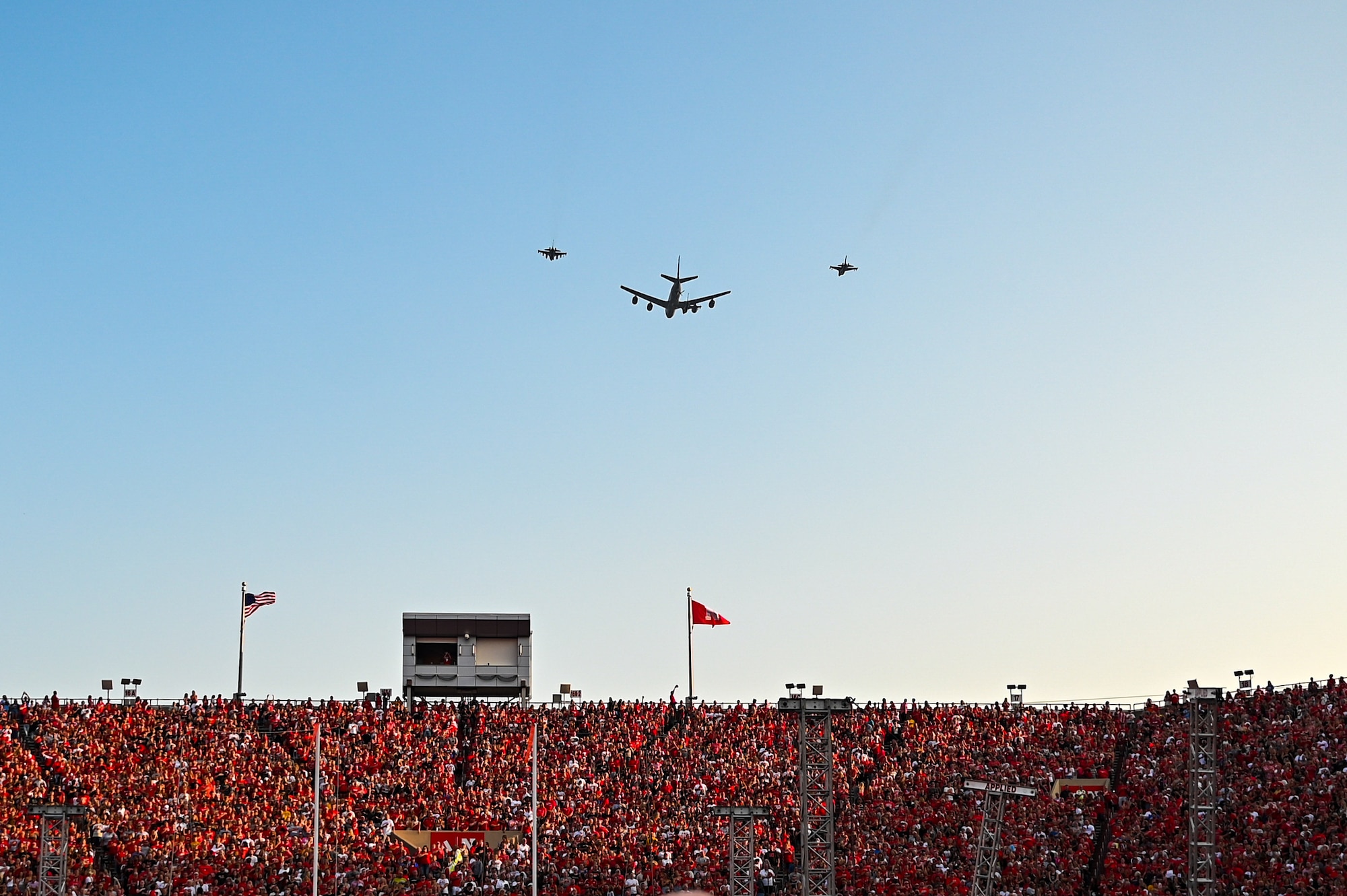A KC-135R Stratotanker assigned to the 155th Air Refueling Wing flies over Memorial Stadium with F-16 Fighting Falcons assigned to the 114th Fighter Wing during the national anthem for the University of Nebraska volleyball game in Lincoln, Nebraska, Aug. 30, 2023. The event broke the world record for women’s sporting event attendance with 92,003 fans.