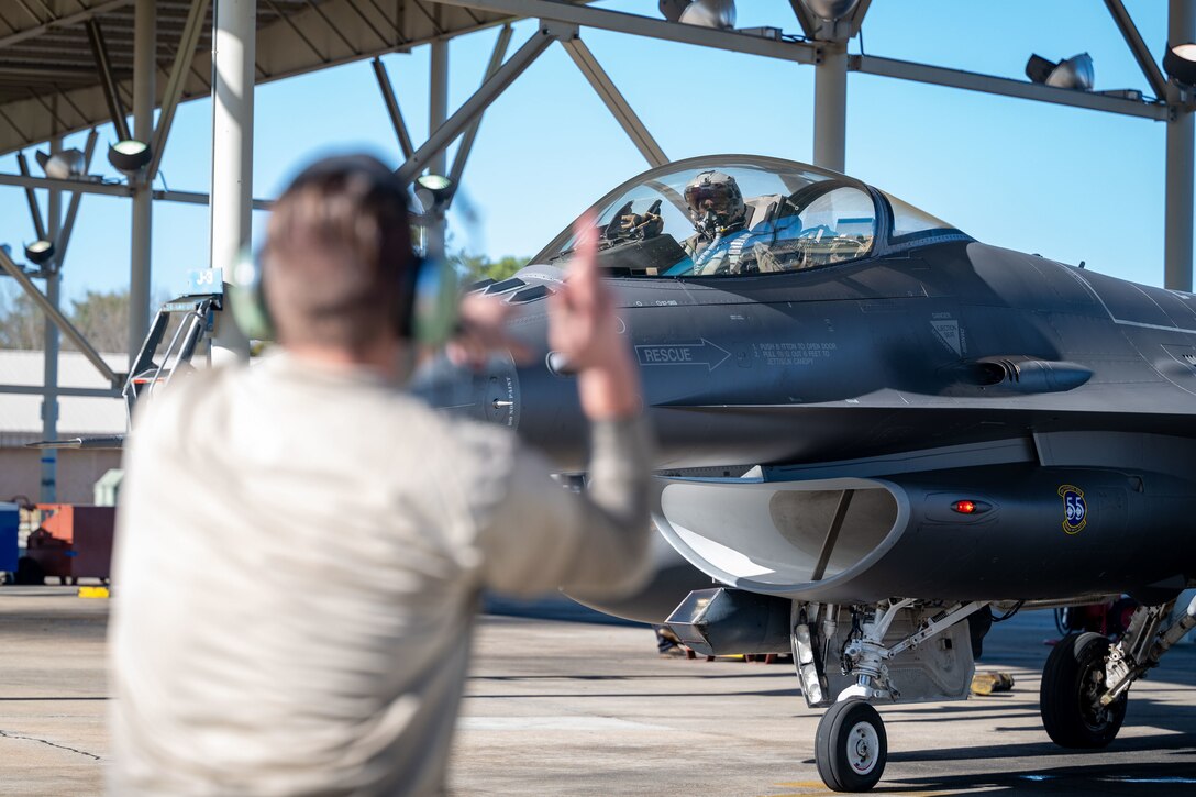 U.S. Air Force Airman Thomas Heester Jr., 55th Fighter Generation Squadron assistant dedicated crew chief, marshals a U.S. Air Force F-16C Fighting Falcon on the flightline at Shaw Air Force Base, S.C., Jan. 5, 2023.