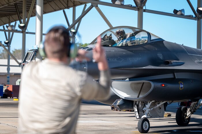 U.S. Air Force Airman Thomas Heester Jr., 55th Fighter Generation Squadron assistant dedicated crew chief, marshals a U.S. Air Force F-16C Fighting Falcon on the flightline at Shaw Air Force Base, S.C., Jan. 5, 2023.