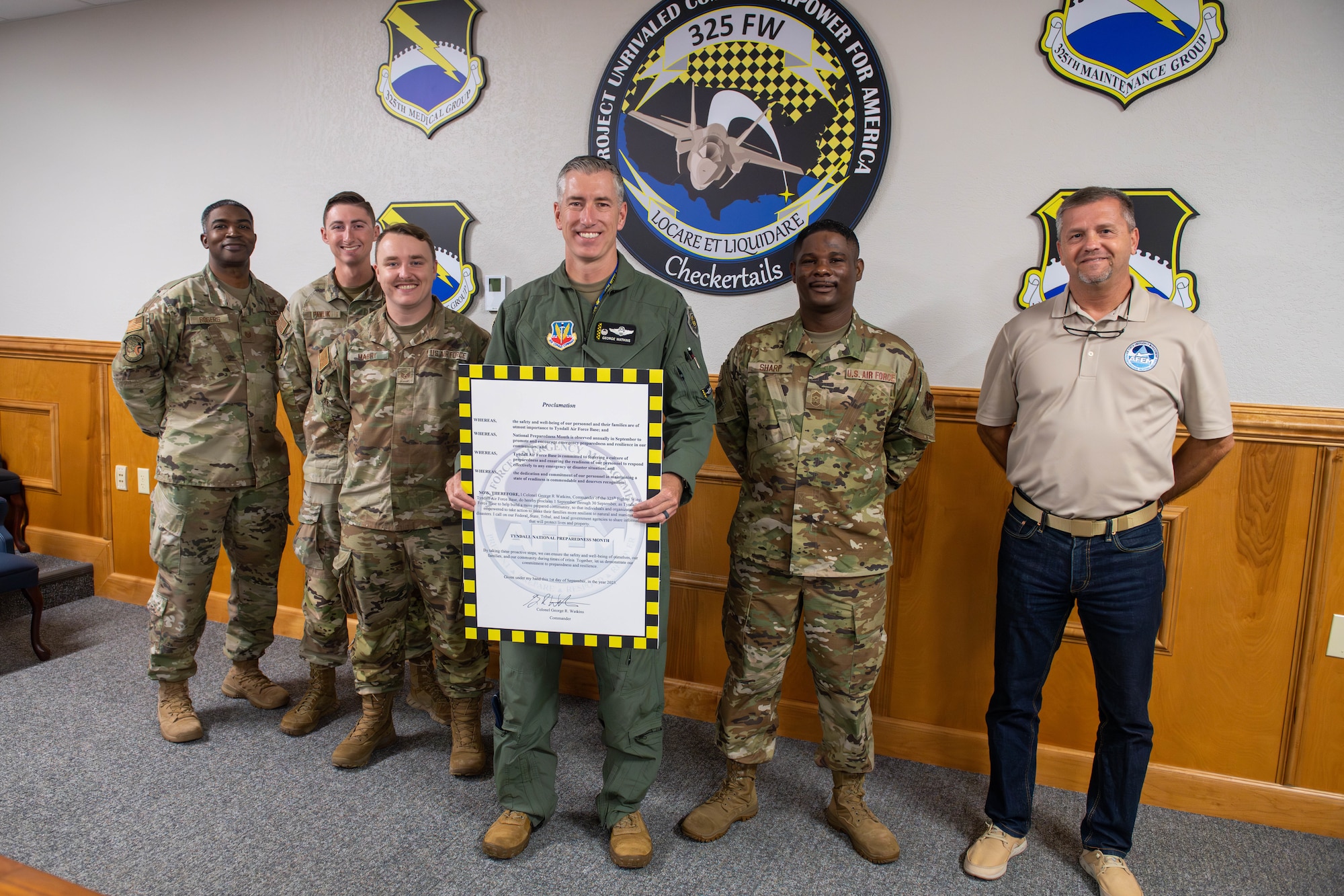 Airmen pose for a photo.