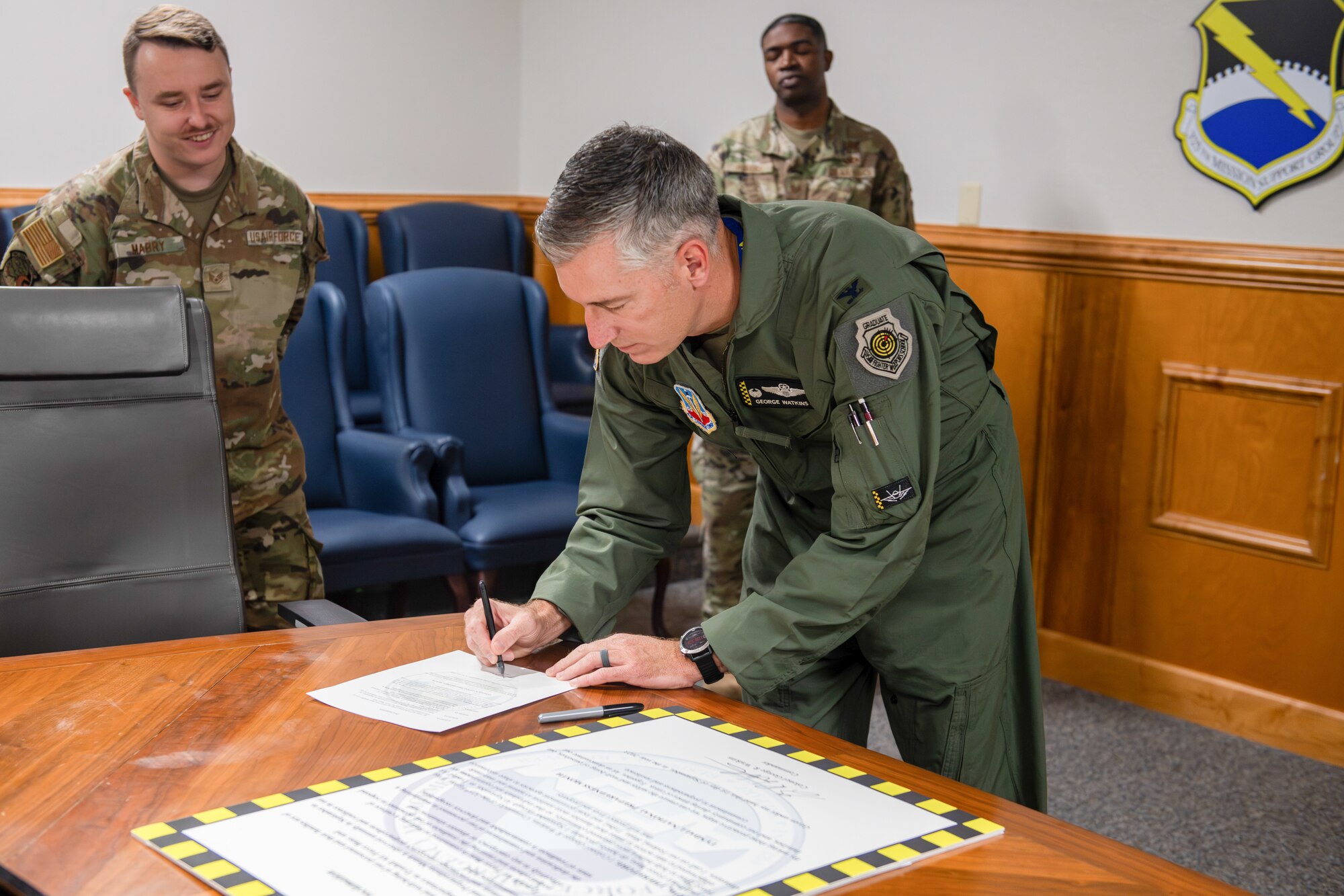 Commander signs document.