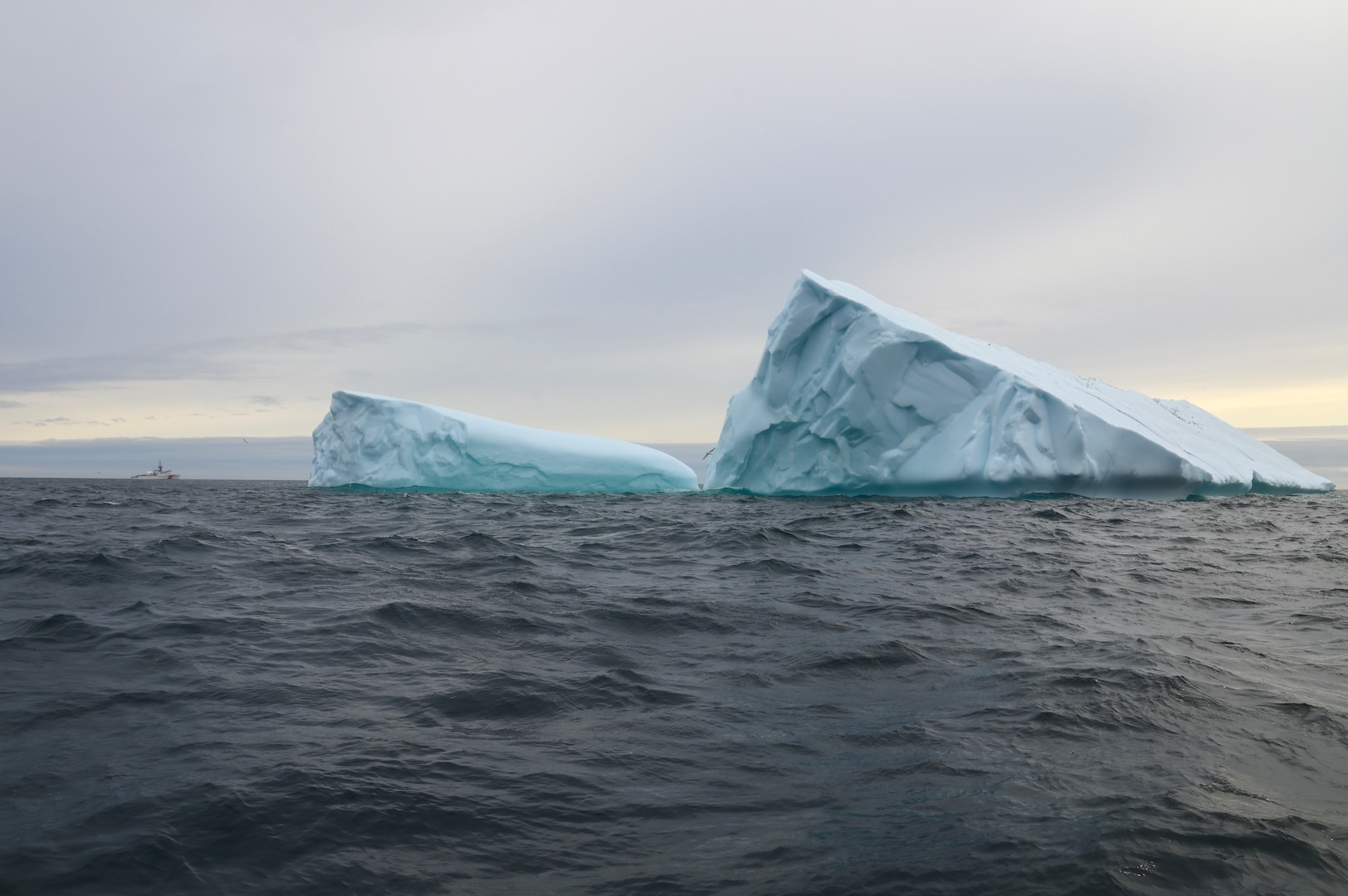 The U.S. Coast Guard Cutter Forward (WMEC 911) steams near an iceberg in the Atlantic Ocean, Aug. 22, 2023. Forward deployed in support of Op Nanook, an annual Canadian-led exercise that offers an opportunity to work with partners to advance shared maritime objectives. (U.S. Coast Guard photo by Petty Officer 3rd Class Mikaela McGee)