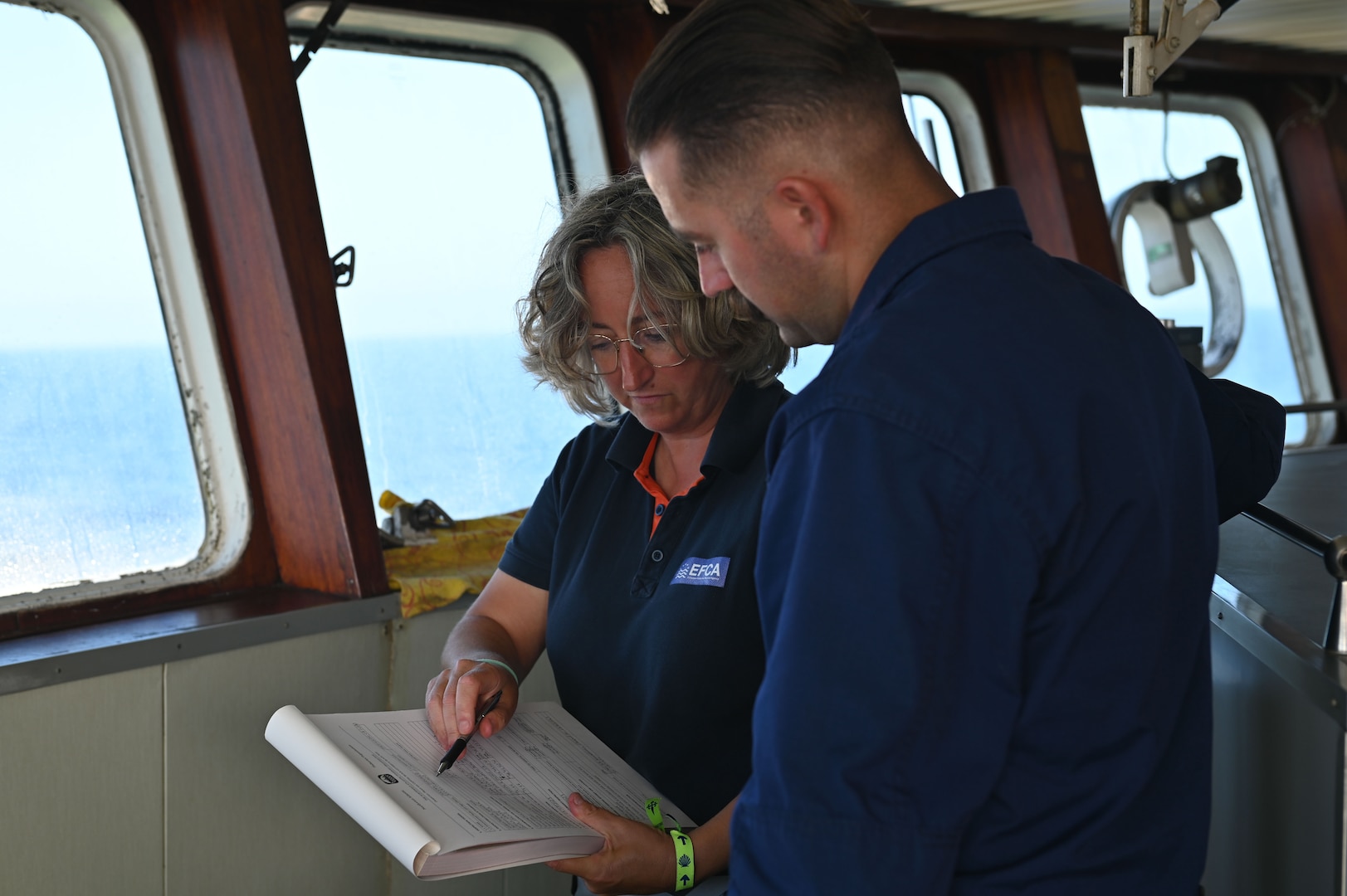 Idoia Sáenz, a European Fisheries Control Agency inspector, and U.S. Coast Guard Petty Officer 1st Class Anthony Hotka, a crew member assigned to U.S. Coast Guard Cutter Forward (WMEC 911), conduct a routine Northwest Atlantic Fisheries Organization inspection at sea in the Atlantic Ocean, Sept. 5, 2023. Forward conducted a NAFO patrol and joined international partners to deter illegal, unreported, and unregulated fishing and manage valuable global fish stocks. (U.S. Coast Guard photo by Petty Officer 3rd Class Mikaela McGee)