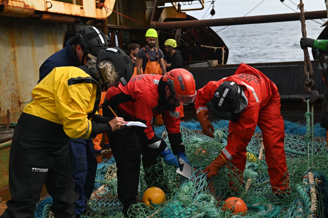 Coast Guardsmen assigned to U.S. Coast Guard Cutter Forward (WMEC 911) assist fisheries inspectors with the Northwest Atlantic Fisheries Organization to measure a fishing net while at sea in the Atlantic Ocean, Sept. 5, 2023. Forward conducted a NAFO patrol and joined international partners to deter illegal, unreported, and unregulated fishing and manage valuable global fish stocks. (U.S. Coast Guard photo by Petty Officer 3rd Class Mikaela McGee)