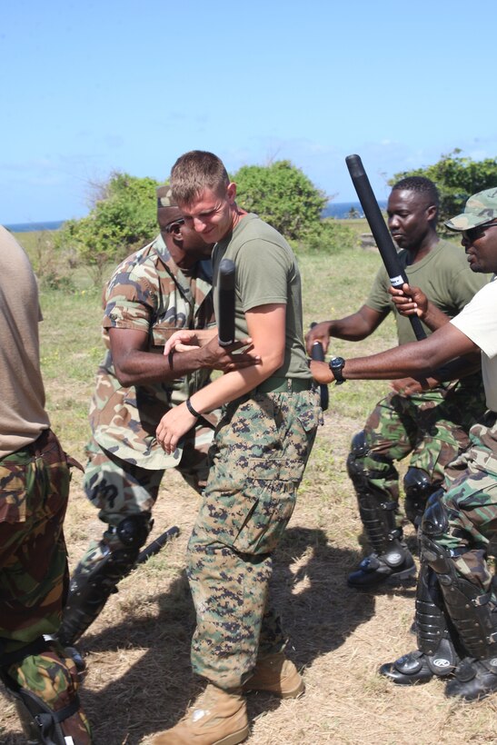 U.S. Marine Sgt. Andrew Mercer, a military policeman from Military Police Company B, Headquarters and Service Battalion, 4th Marine Logistics Group, and an Allentown, Pa. native, leads students during a crowd control practice at Barbados Defence Force Base Paragon, Christ Church, Barbados, June 18, 2012, for Exercise Tradewinds 2012. Tradewinds is a multinational, interagency exercise designed to develop and sustain relationships that improve the capacity of U.S., Canadian and 15 Caribbean partner nations security forces to counter transnational crime and provide humanitarian assistance and disaster relief.