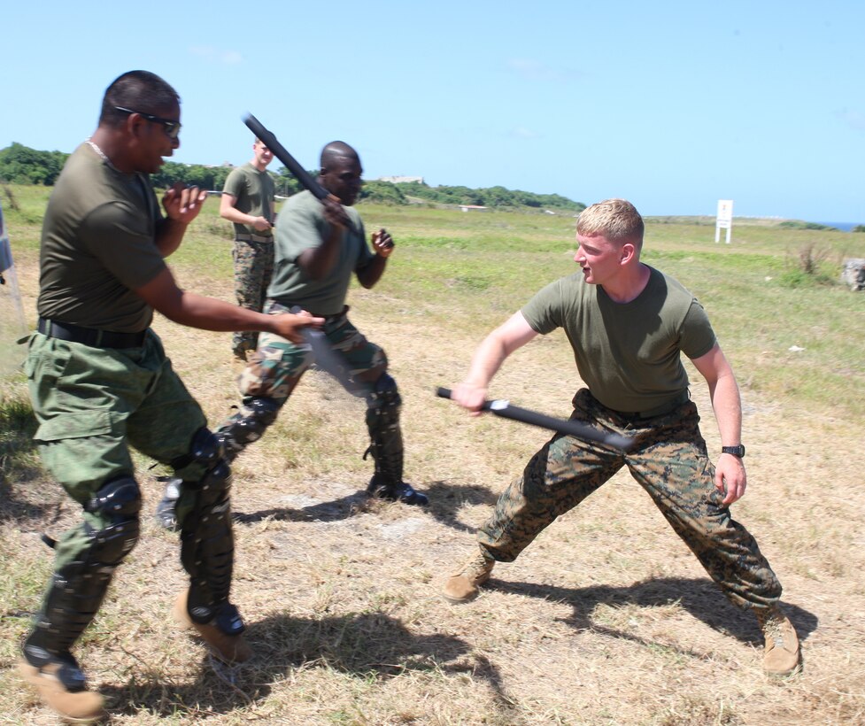 U.S. Marine Sgt. Caleb Love, a military policeman from Military Police Company B, Headquarters and Service Battalion, 4th Marine Logistics Group, and a Claysburg, Pa., native, fends off students for a crowd control practice at Barbados Defence Force Base Paragon, Christ Church, Barbados, June 18, 2012, during Exercise Tradewinds 2012. Tradewinds is a multinational, interagency exercise designed to develop and sustain relationships that improve the capacity of U.S., Canadian and 15 Caribbean partner nations security forces to counter transnational crime and provide humanitarian assistance and disaster relief.