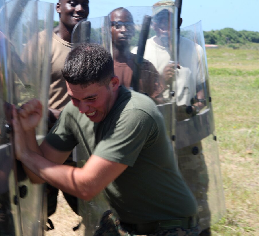 U.S. Marine Lance Cpl. Thomas Wilson, a military policeman from Military Police Company B, Headquarters and Service Battalion, 4th Marine Logistics Group, and a Pittsburgh native, tries to penetrate students' formation in a crowd control practice at Barbados Defence Force Base Paragon, Christ Church, Barbados, June 18, 2012, during Exercise Tradewinds 2012. Tradewinds is a multinational, interagency exercise designed to develop and sustain relationships that improve the capacity of U.S., Canadian and 15 Caribbean partner nations security forces to counter transnational crime and provide humanitarian assistance and disaster relief.
