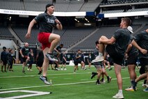 U.S. Air Force Airmen perform warmup exercises during the United Services Automobile Association Salute to Service Boot Camp at Allegiant Stadium, Las Vegas, Nevada, Sept. 19, 2023.