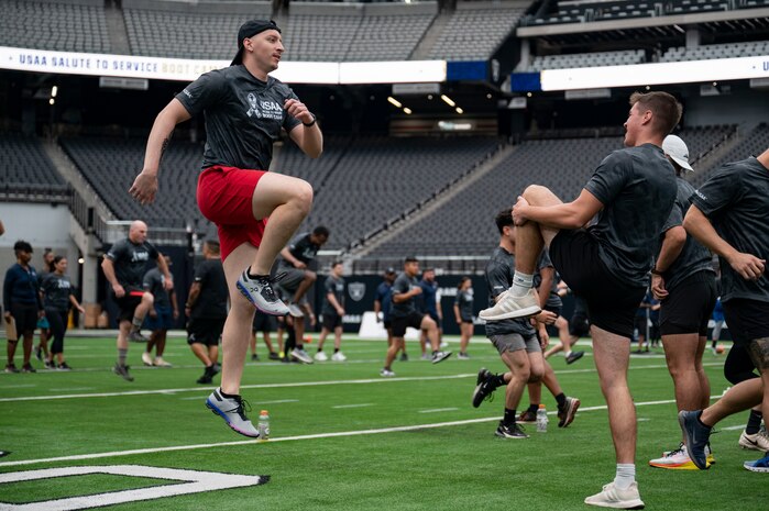 U.S. Air Force Airmen perform warmup exercises during the United Services Automobile Association Salute to Service Boot Camp at Allegiant Stadium, Las Vegas, Nevada, Sept. 19, 2023.