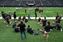 U.S. Air Force Airmen warm up before performing football drills during the United Services Automobile Association Salute to Service Bootcamp at Allegiant Stadium, Las Vegas, Nevada, Sept. 19, 2023.