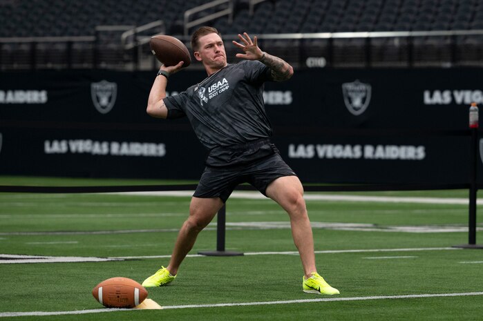 U.S. Air Force Staff Sgt. Taylor Thagard, 99th Civil Engineer Squadron fire and emergency services NCO in charge of training, throws a football during the United Services Automobile Association Salute to Service Bootcamp at Allegiant Stadium, Las Vegas, Nevada, Sept. 19, 2023.