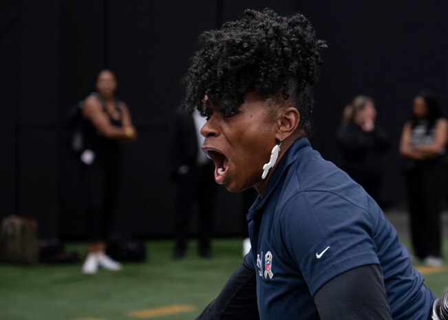 A United Services Automobile Association (USAA) volunteer coach hypes up Airmen running the 40-yard dash during the USAA Salute to Service Bootcamp at Allegiant Stadium, Las Vegas, Nevada, Sept. 19, 2023.