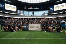 U.S. Air Force Airmen and Las Vegas Raiders players gather for a group photo during the United Services Automobile Association Salute to Service Boot Camp at Allegiant Stadium, Las Vegas, Nevada, Sept. 19, 2023.
