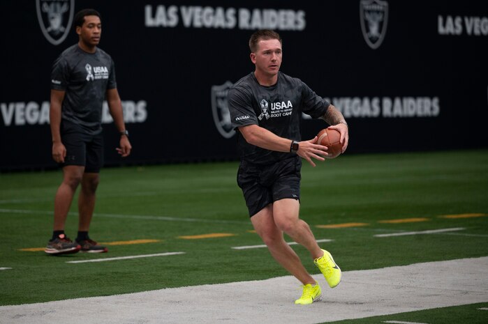 U.S. Air Force Staff Sgt. Taylor Thagard, 99th Civil Engineer Squadron fire and emergency services NCO in charge of training, runs football drills during the United Services Automobile Association Salute to Service Bootcamp at Allegiant Stadium, Las Vegas, Nevada, Sept. 19, 2023.