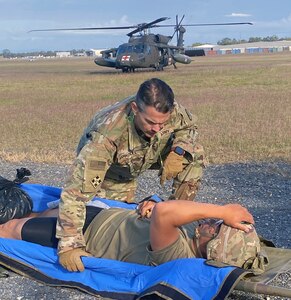 Maj. Thad Barkdull, chief medical officer with the 144th Area Support Medical Company, Utah Army National Guard, conducts an evaluation of an injured Soldier during a Medical Evacuation at Talisman Sabre, Camp Rocky, Rockhampton, Australia, August 2, 2023. Talisman Sabre is a large-scale, bilateral military exercise between Australia and the United States, which strengthens relationships and interoperability among key allies and enhances collective capabilities to respond to a wide array of potential security concerns. This will be the 10th iteration of the exercise. (Capt. Jessica Delph)