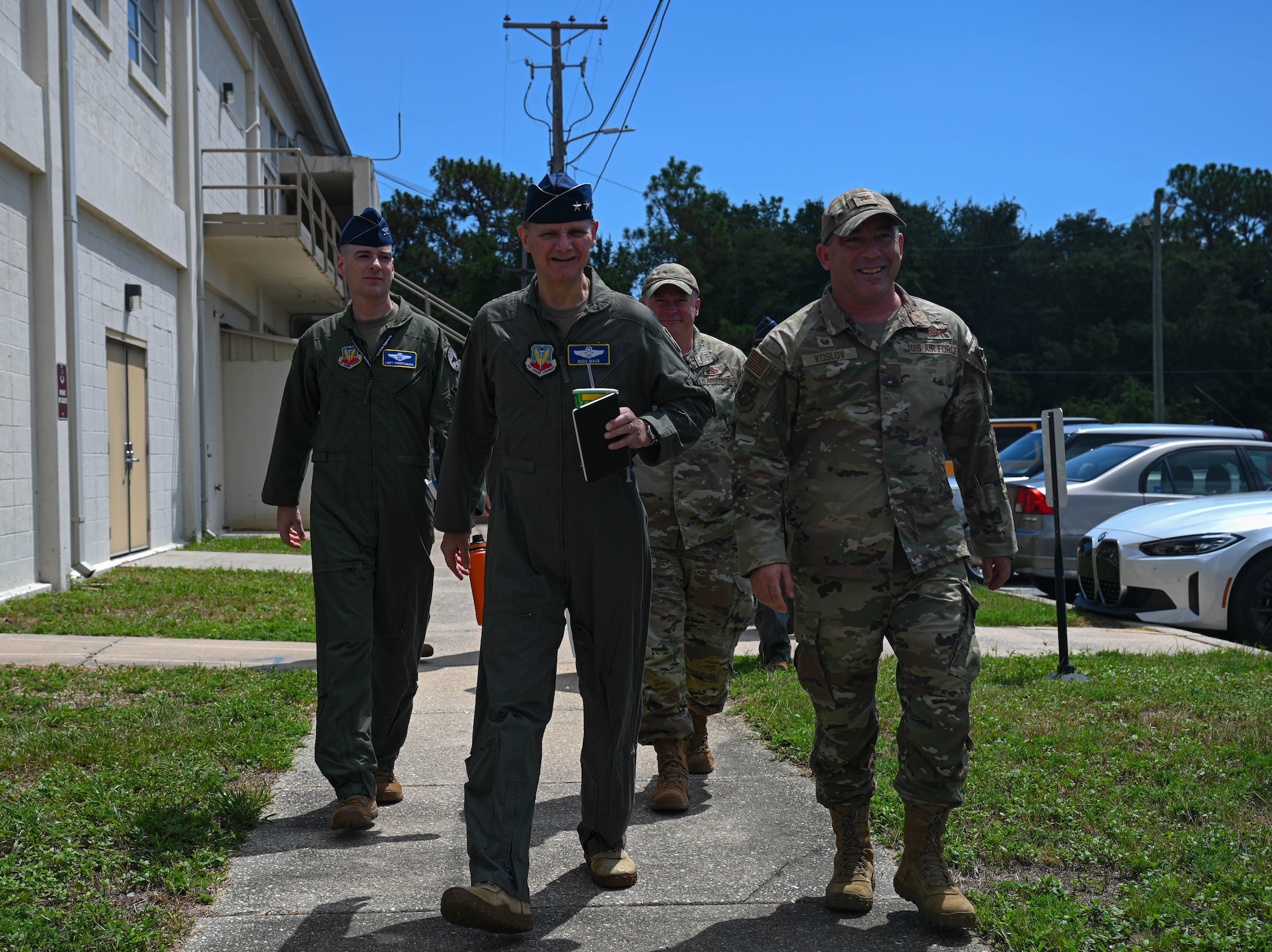 U.S. Air Force Lt. Gen. Russ Mack, deputy commander of Air Combat Command, center, walks with Col. Josh Koslov, 350th Spectrum Warfare Wing commander, right, and leadership during a visit to the wing at Eglin Air Force Base, Fla., Sept. 6, 2023. Mack visited the wing to learn more about its mission to develop and employ Electronic Warfare capabilities to warfighters. (U.S. Air Force photo by Capt. Benjamin Aronson)
