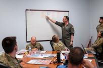 Lt. Col. Adam Baker, 7th Bomb Wing director of wing plans, reviews his main operating base’s current situation during a table-top exercise.