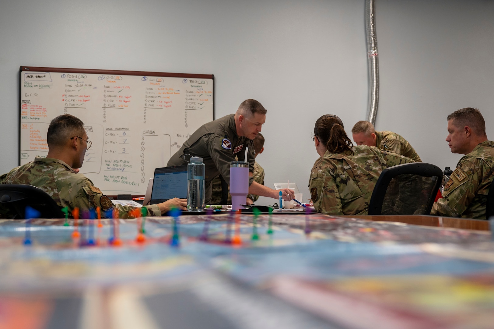 Leadership assigned to Dyess Air Force Base, Texas, and an instructor assigned to the 705th Training Squadron discuss plans during a table-top exercise.