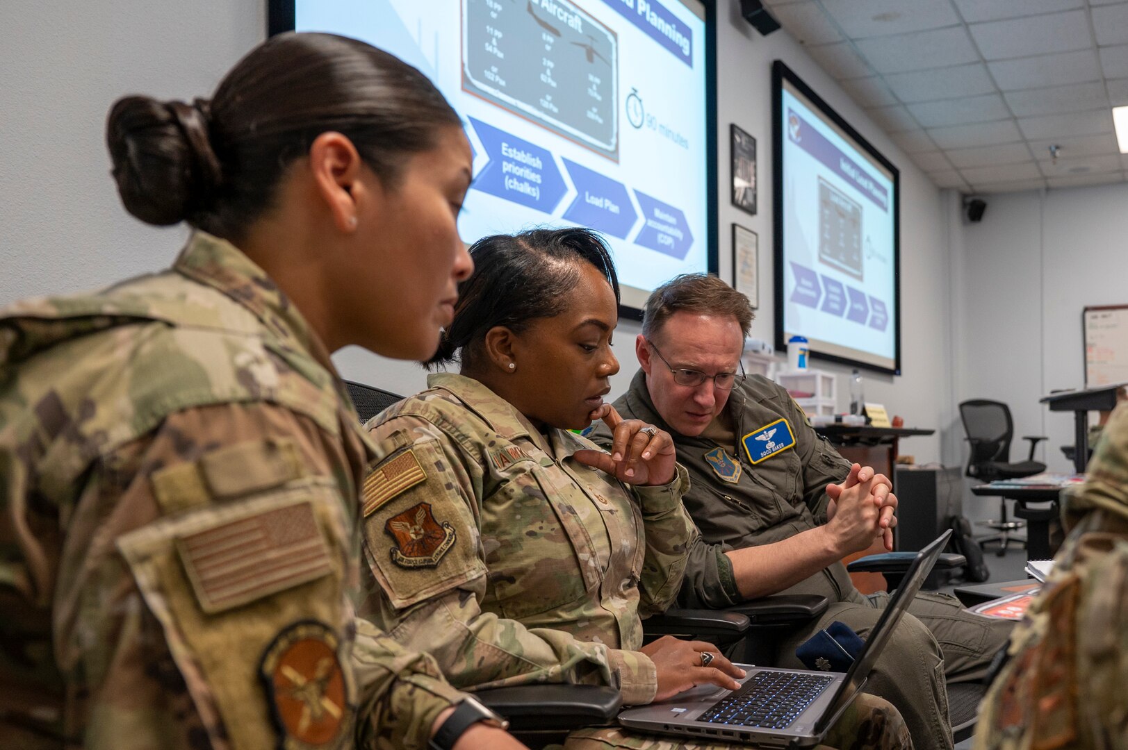 Leadership assigned to Dyess Air Force Base, Texas, look over notes during a table-top exercise.