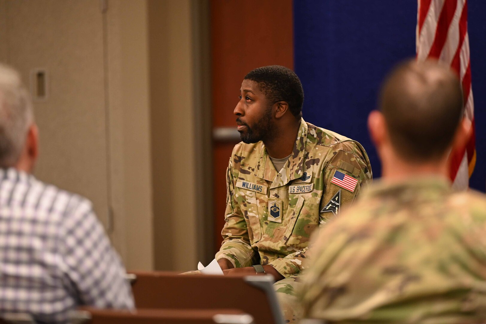 Man sits and speaks to audience