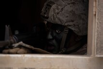 U.S. Marine Corps Cpl. Malik Dowe, a student with Marine Corps Air Station Kaneohe Bay Corporals Course 3-23, scans for simulated hostiles during urban operations training, Marine Corps Training Area Bellows, Marine Corps Base Hawaii, Sept. 14, 2023. The course provided Marine noncommissioned officers with the skills and knowledge necessary to become successful small-unit leaders. (U.S. Marine Corps photo by Lance Cpl. Hunter Jones)