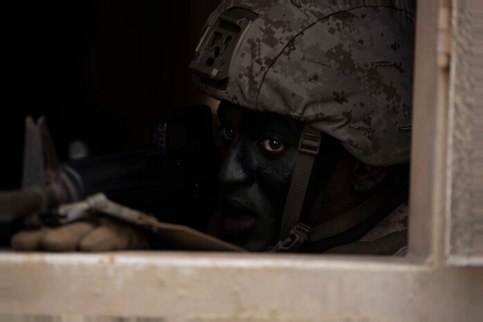 U.S. Marine Corps Cpl. Malik Dowe, a student with Marine Corps Air Station Kaneohe Bay Corporals Course 3-23, scans for simulated hostiles during urban operations training, Marine Corps Training Area Bellows, Marine Corps Base Hawaii, Sept. 14, 2023. The course provided Marine noncommissioned officers with the skills and knowledge necessary to become successful small-unit leaders. (U.S. Marine Corps photo by Lance Cpl. Hunter Jones)