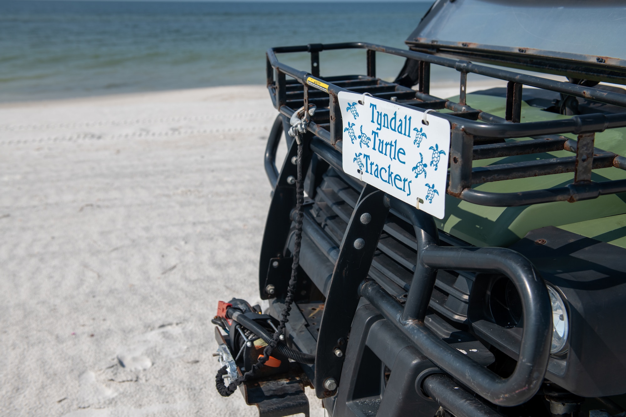 ATV parked on beach.