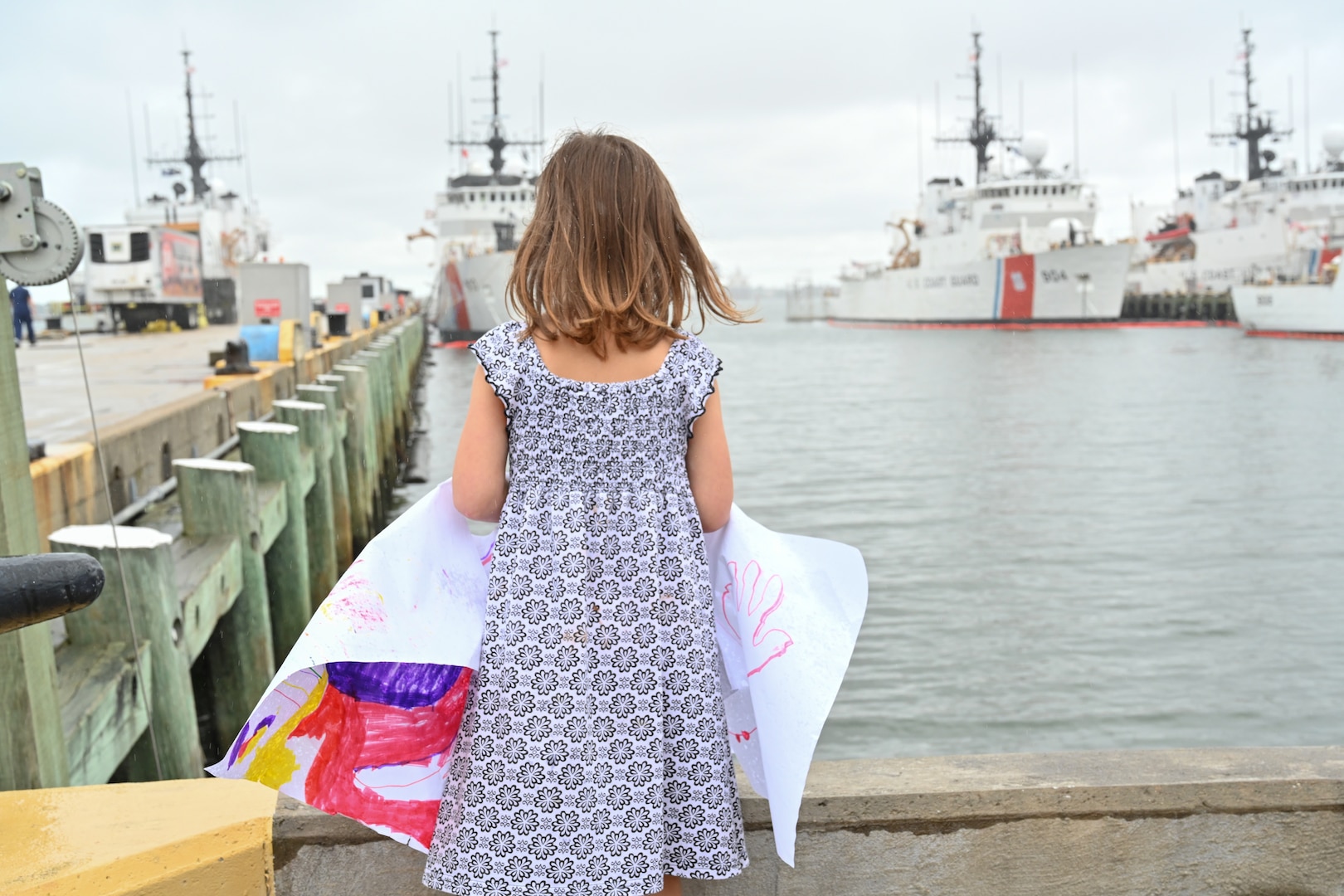 A young girl awaits the return of U.S. Coast Guard Cutter Forward (WMEC 911), Sept. 26, at the pier in Portsmouth, Virginia. Forward completed a two-and-a-half month-long patrol in the North Atlantic Ocean to support the Coast Guard Arctic Strategy and participate in the Canadian Armed Forces-led Operation Nanook 2023, an annual military exercise conducted to strengthen shared maritime objectives in the high northern latitudes. (U.S. Coast Guard photo by Petty Officer 2nd Class Brandon Hillard)