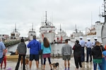 Family and friends of U.S. Coast Guard Cutter Forward's (WMEC 911) crew watch the cutter approach the pier, Sept. 26, in Portsmouth, Virginia. Forward completed a two-and-a-half month-long patrol in the North Atlantic Ocean to support the Coast Guard Arctic Strategy and participate in the Canadian Armed Forces-led Operation Nanook 2023, an annual military exercise conducted to strengthen shared maritime objectives in the high northern latitudes. (U.S. Coast Guard photo by Petty Officer 2nd Class Brandon Hillard)