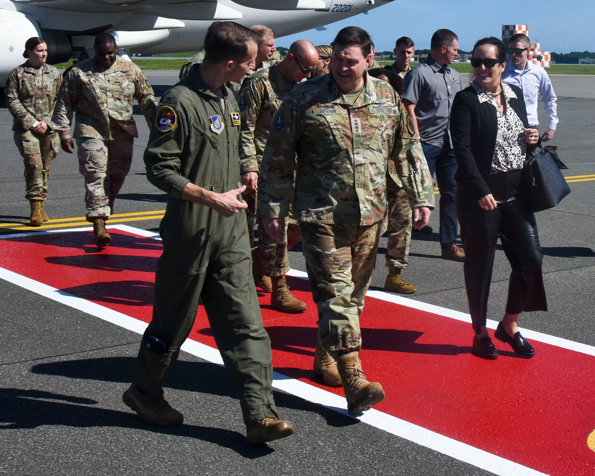 Two military member walk and talk.