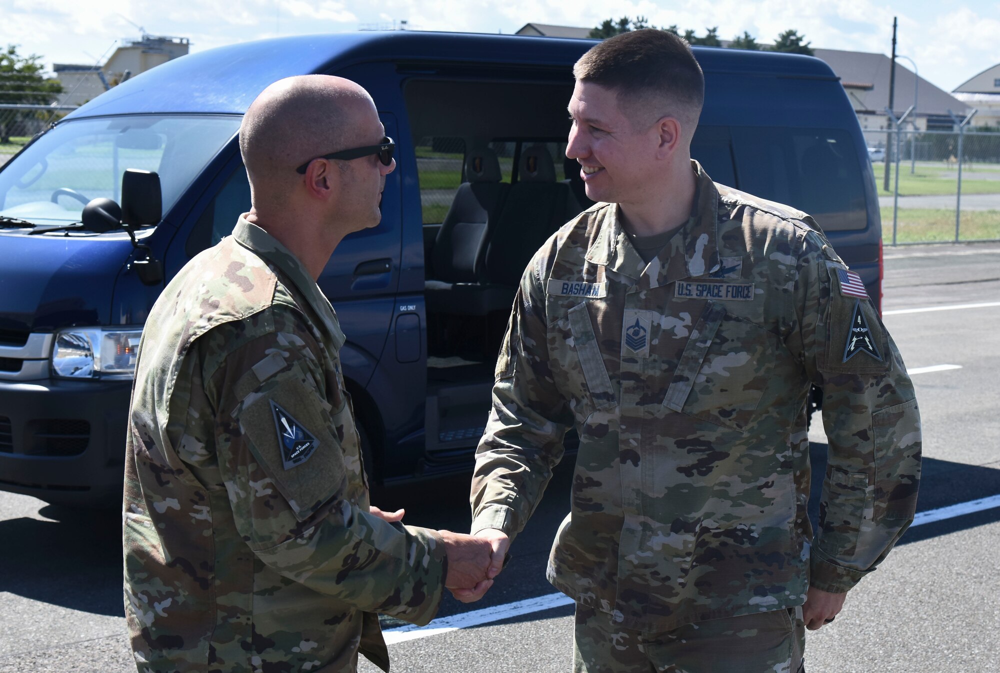 A military member coins another on the flight line