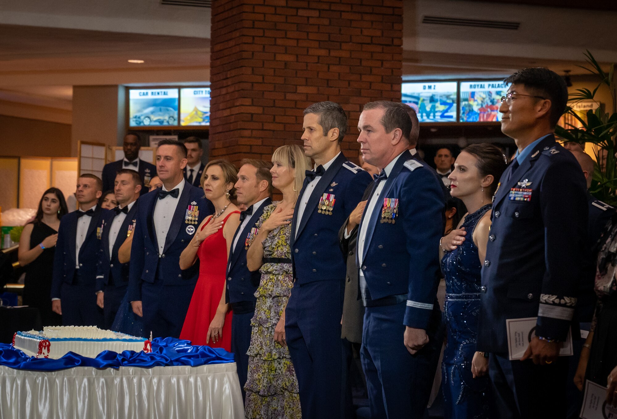 Distinguished guests stand during the singing of the national anthems during the 76th Air Force Ball at U.S. Army Garrison Yongsan, Republic of Korea, Sept. 23, 2023. The peninsula-wide gathering brought together Airmen, families and ROK partners for a night of unity and recognition to commemorate 76 years of air power. 2023 marks the 70th year of the ROK-U.S. alliance and the event hosted not only U.S., but ROK service members, commemorating a historic year and honoring the partnership. (U.S. Air Force photo by Staff Sgt. Kelsea Caballero)